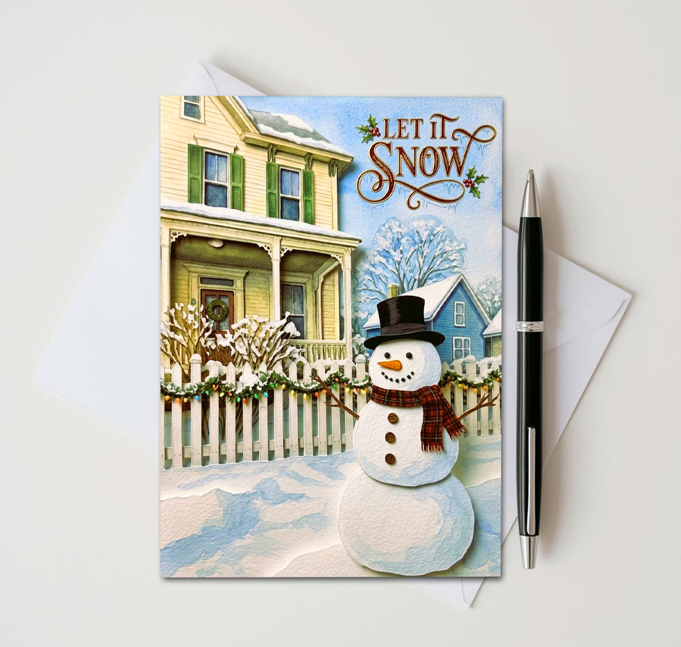 Let It Snow card with top-hat snowman beside a white picket fence and yellow house
