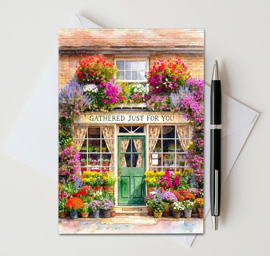Greeting card with a floral shop design and 'Gathered Just for You' text, accompanied by a pen and envelope.