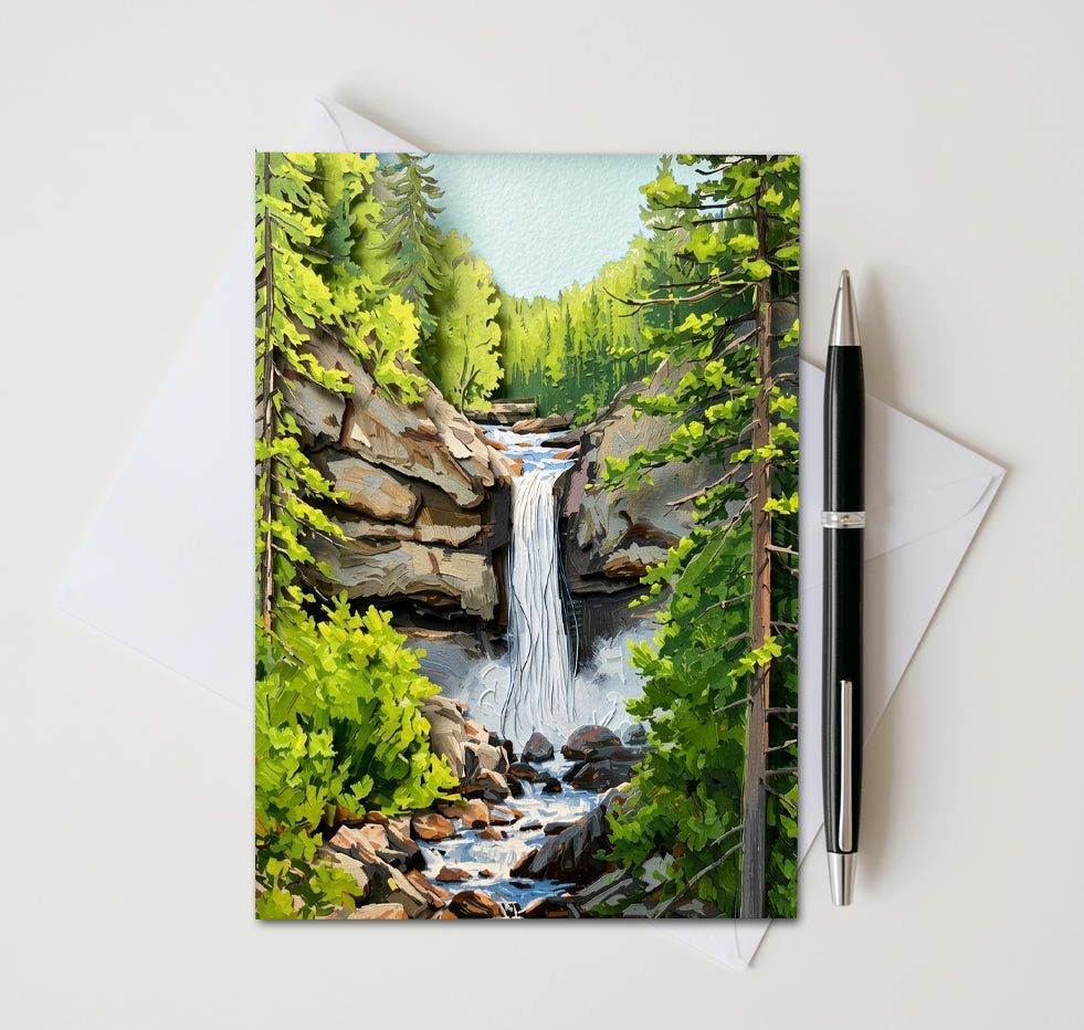 Greeting card with a waterfall design, pen, and envelope on a white background
