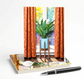 Set of 8 note cards with a peace lily plant in front of a window as subject. cards sitting on white surface with a pen in front.