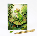 Note Card of frog with a crown on a leaf surrounded by greenery, with a gold pen next to it.