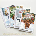 Set of 12 dachshund Christmas cards with four snowy dog designs and white envelopes
